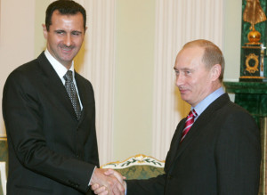 Russia's President Putin and Syrian President Bashar al-Assad  shake hands as they meet in Moscow